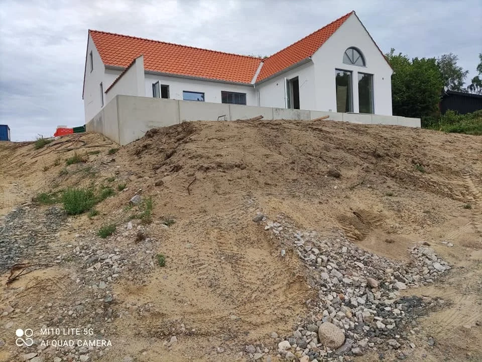 Husbygge med putsad fasad och tegeltak, Österlen Byggservice